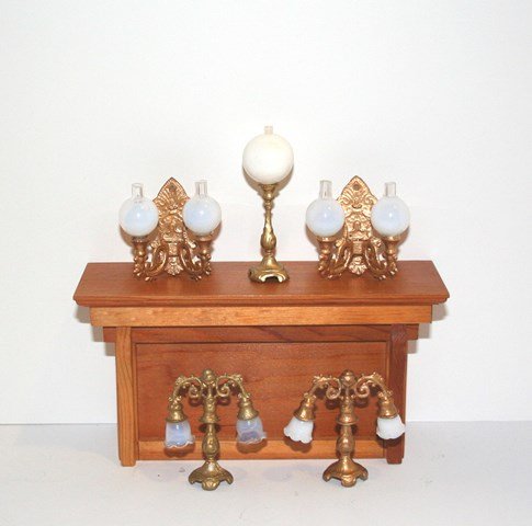 Antique Lamps and Sconces: Five gilt metal lighting fixtures: two double-armed candelabras 2" H with ruffled shades, two wall sconces (globes loose) and a single table lamp. All appear to be repainted, but display nicely. DISPL