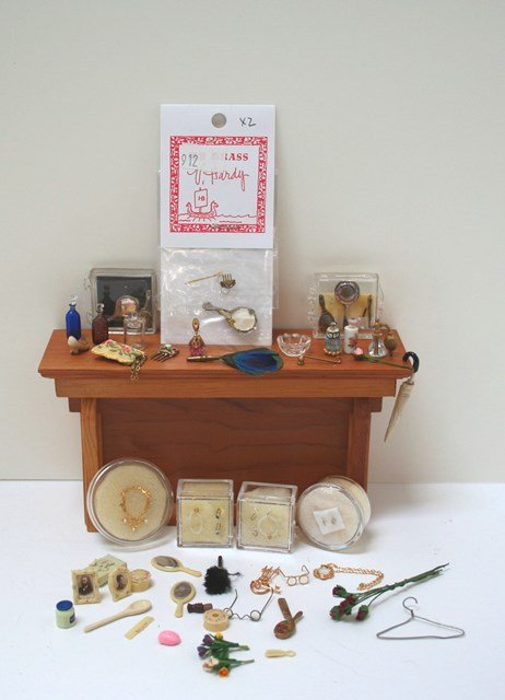 Dressing Table Accessories: For Lady Grantham's dressing table: beautifully scaled jewelry sets, toilette items, hair comb, purse, stoppered bottles (probably Whittemore) and a peacock feather fan 1.75" L. Wood display cabinet N