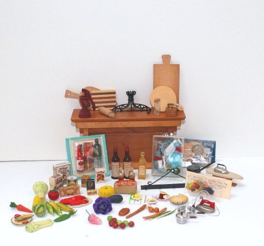 Miniature Groceries and Cutting Boards: Large assortment of nicely crafted fruits and vegetables old-fashioned grocery boxes by Lorraine Scuderi. Box of detailed plastic tableware, cutting boards and pot racks. A mix of artisan and commerci