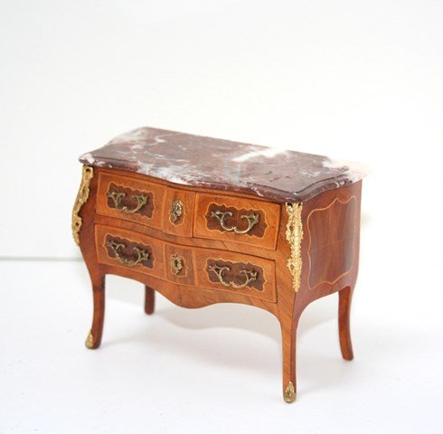 Herbillon Commode: Pretty fruitwood veneers distinguish this Louis XV four-drawer commode with marble top and decorative ormolu mounts. Both legs on the left have been broken and poorly repaired, otherwise it looks love