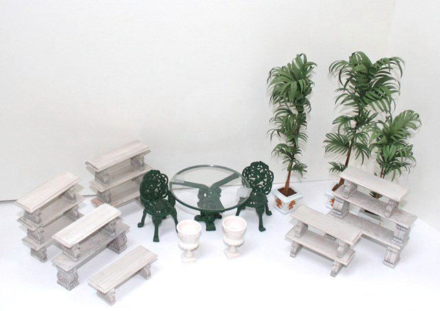 Garden Furniture: A painted cast metal patio set with table 2.5" H, 4" W, three potted palm trees and over a dozen cast resin masonry benches.