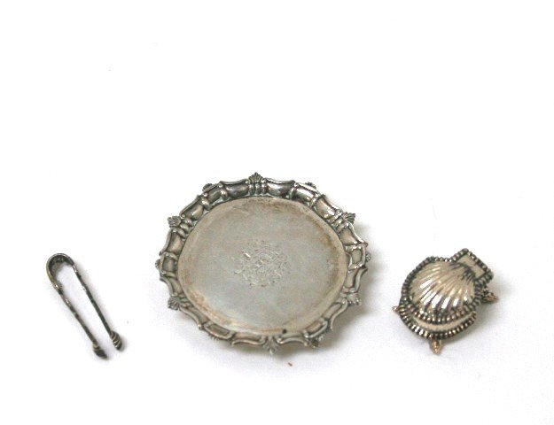 Acquisto Silver: A three-footed sterling slaver with fluted and raised edging and engraved decoration 1" diameter, copied from one by Paul Revere and an English shell-form sugar or spice box, and sugar tongs, all by P