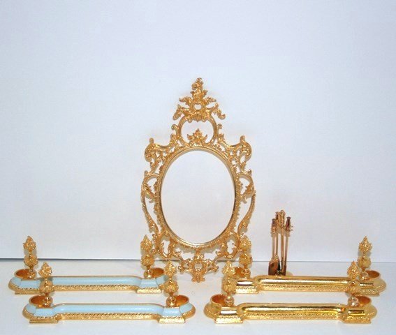 Sue Cook Fenders: Four of Sue Cook's heavy cast metal fireplace fenders 5" L and an elaborate cast metal frame 6.5" H, 3.5" W. Also a set of brass fireplace tools.