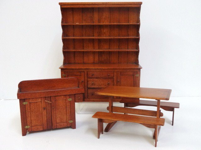 Hank Miller Colonial Dining Group: An imposing pine Welsh dresser 7.5" H, just over 6" W, a trestle table with two benches and a dry sink, all by Hank Miller, undated. Very nice finish on all his pieces.