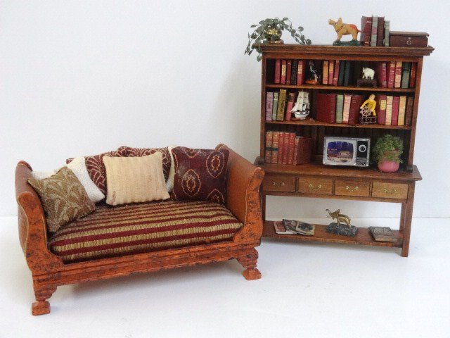Lorraine Scuderi Daybed: A very comfy-looking upholstered daybed with faux tortoiseshell finish, leather sides and piled high with pillows glued in place 3.5" H, 6.5" L. Paired with a country dresser with hand-painted decorat