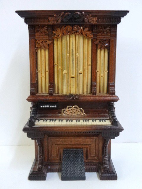 George Becker Pipe Organ: Handsome and elaborately carved Victorian pipe organ numbered 331. 7" H, 4.5" W.