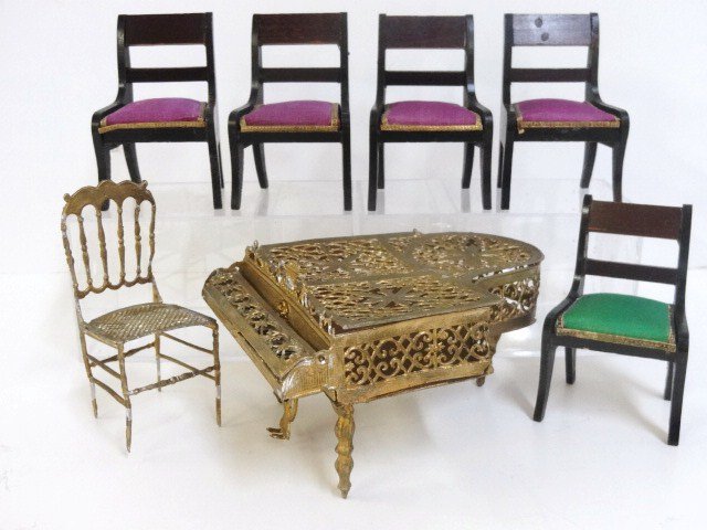 Antique Chairs and Piano: Let the concert commence! A gilt soft filigree metal baby grand piano 4.5" L with hinged lid and keyboard cover, a gilt soft metal chair and five antique Waltershausen upholstered side chairs.