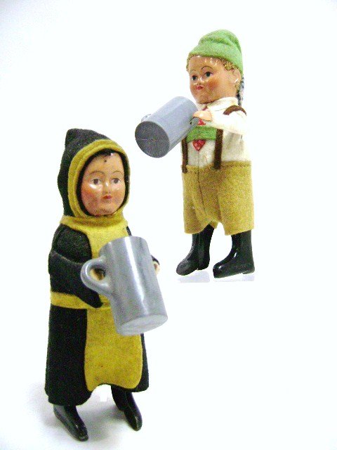 Schuco Pair of Drinkers: Pair of Schuco wind-up drinkers in ethnic dress, tin faces with felt costumes, 5"H, raises mug to face and spins in circles