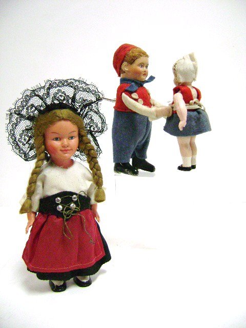 Schuco Wind-Up Dancer and Other: Schuco Dancing Boy with tin face and felt clothes lifts a celluloid girl and spins, 5" H, and an unmarked celluloid dancer with ethnic costume 6.25" H