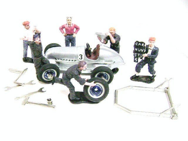 Schuco Studio Mercedes Racer Set: Silver Mercedes Racer wind-up 5 1/3"L along with six team members, rack and tools, instructions, wood/glass case