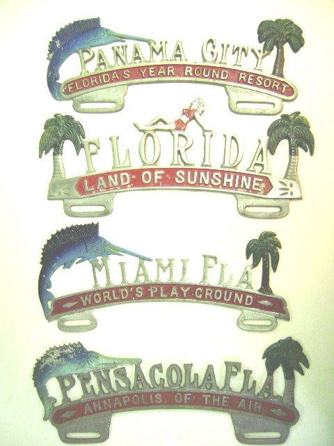 Four Florida License Plate Toppers: Four vintage aluminum Florida license plate toppers, Panama City Florida's Year Round Resort, Florida Land of Sunshine, Miami Florida World's Play Ground, Pensacola Florida Annapolis of the Air
