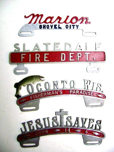 Four License Plate Toppers: Four vintage aluminum license plate toppers, Marion Shovel City [Ohio], Oconto Wis Fisherman's Paradise, Jesus Saves John 14-6, Slatedale Fire Dept.
