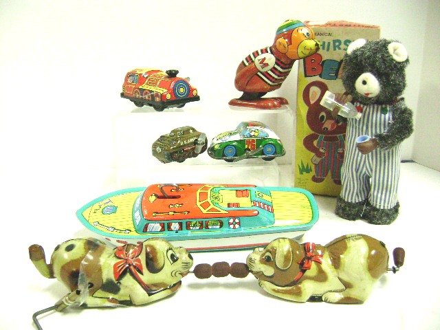 Group of Seven Vintage Wind-Up Toys: Alps Thirsty Bear in O.B., Chein Speed Boat, Rolling Dogs, Yone Monkey, Esso advertising car and Japanese locomotive, bear is 7" H