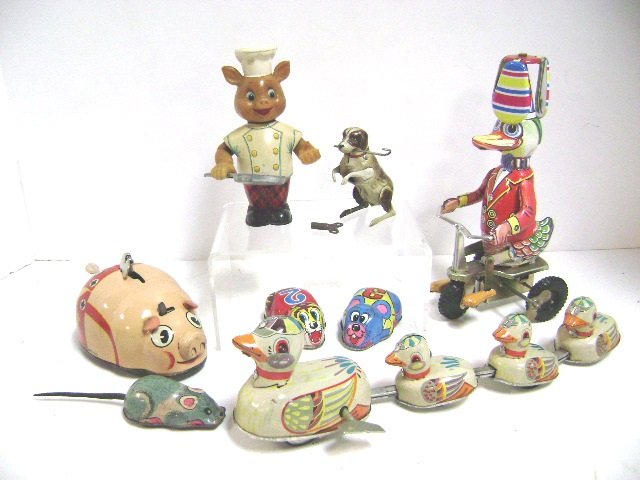 Eight Tin Wind-Up and Friction Animals: Mother duck with ducklings wind-up, duck on trike with propeller hat, Y Japan wind-up chef pig, U.S. Zone Germany jumping dog, Japan mouse, friction cat and mouse, longest 12"