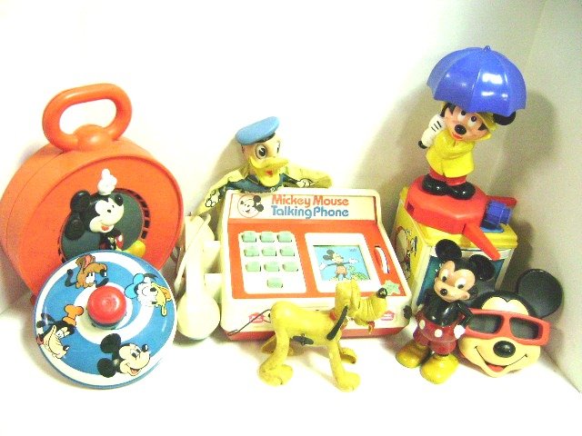 Group of Mickey Mouse Toys: Three View Masters, hose sprinkler, tin top, Marx wind-up walker, rubber doll, hand puppet, wind-up Pluto, wind-up Daffy, plastic Daffy with wheel barrow, set of 4 small Marx bobble heads, Donald Duck