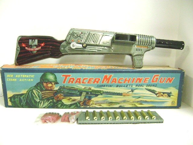 1950's Sankei Tin Machine Gun: Sankei, Japan, tin silver Eagle Tracer Machine Gun in original box with metal spring loaded clip with 20 factory sealed bullets that shoot up to 30 feet, 20.5" L, marked with circle K logo