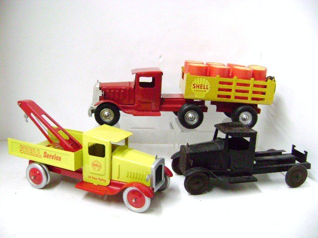Three Metalcraft Style Trucks: Contemporary Shell tractor trailer with seven plastic shell barrels 14" L, contemporary Shell tow truck 10.5" L, great looking fantasy pieces, also an original Metalcraft truck without body