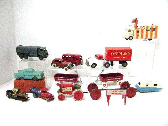 Large Group of Toy Vehicles: Eleven pieces total, tin Overland Freight Service Truck 7" L, Animate Toy tin baby tractor with trailer 11" L, repainted bus, two Radio Flyer wagons, Corgi Karrier Gamecock radar truck, Dinky Caravan 