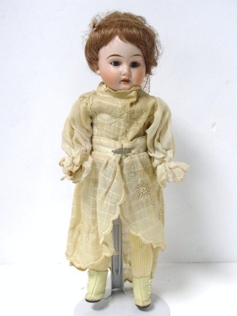 Bisque Head Doll, 12 inches: Bisque head doll, glass eyes, teeth, paper mache, G BR K 44 4/0, original wig, 12 in.