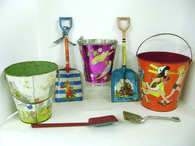 Vintage Tin Sand Pails and Shovels: Three vintage tin sand pails, two by Ohio Art and one by US Metal Toy, and four sand shovels