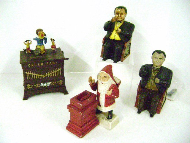 Group Cast Iron Mechanical Bank Reproductions: Santa Claus at Chimney Mechanical Bank, Book of Knowledge Organ Bank with loose arm, Book of Knowledge Tammany Hall Bank and original Tammany Hall Bank with broken arm