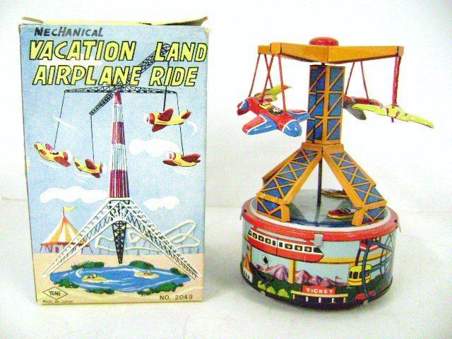 Yone Mechanical Vacation Land Airplane Ride: Yoni Japan tin litho mechanical vacation land airplane ride wind-up, three airplanes circle above while three boats circle below