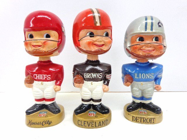 Four Football Bobble Head Lot: Four Bobbles to include: two Sports Spec. Gold base Bobbles, Detroit and Cleveland, oval gold base Minnesota, One pro Novelty Gold Base K.C. Chiefs, Detroit Bobble Autographed By Rick Gody one in ob