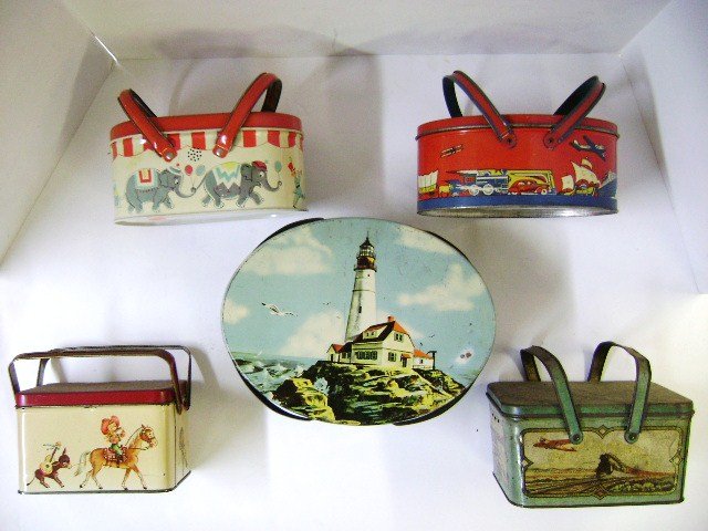 Group Early Lunch Boxes: Great Ohio Art oval lunch box with transportation lithos, oval circus theme box, rectangular transportation theme box, oval large lighthouse theme box and rectangular western theme box