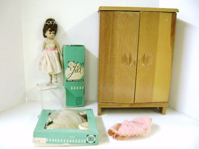 10" Jill Doll by Vogue With Extra Clothing: Hard plastic doll has sleep eyes, walker body with bendable legs, wearing original tagged dress, includes two extra tagged dresses, 17" H wood wardrobe with additional clothes by various makers