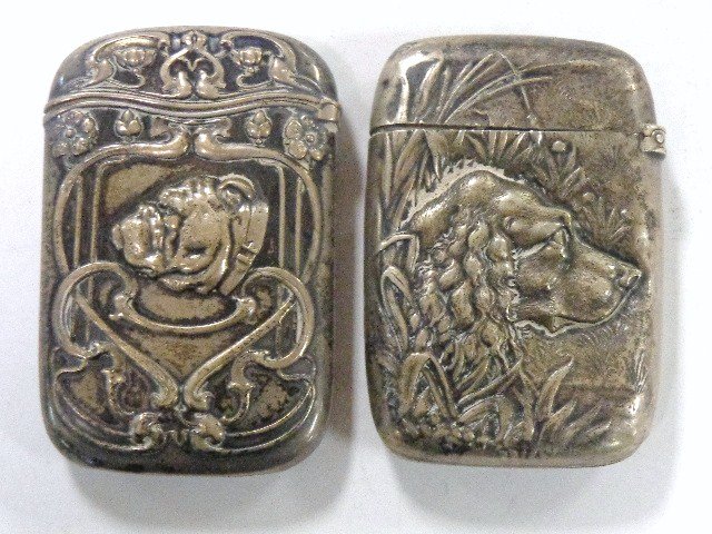 Pair of Sterling Dog Vesta Cases: Pair of sterling vesta cases, head of pointer w/trees on reverse, monogrammed & dated 1896, 2.5 in. (h), ornate art noveau case w/bulldog 2.5 in. (h)
