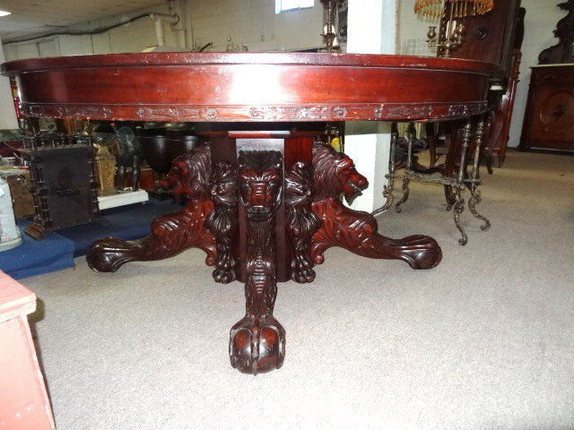 Exceptional Carved Victorian Dining Room Table: Carved solid mahogany dining table 60 in. round top w/carved skirt, massive ornate base w/carved lions & ball & claw feet, one pedestal between each of four carved lions, carved north wind face & carv