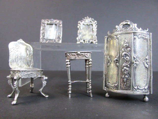 Dollhouse Miniature Silver Furniture: Five pcs. Of miniature silver furniture includes .930 double door armoire 2.6 in. (h), .930 end table w/hinged lid, 2-.925 picture frames & unmarked chair, 3.13 ozt total weight