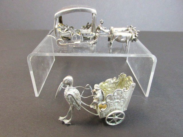 Pair Silver Miniature Carts: Ox drawn sled w/three seated riders, 4 in. (l) w/tiny hallmarks & stork drawn wagon w/unknown hallmarks