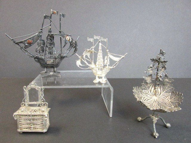 Dollhouse Silver Filigree Miniatures: Lot of four silver filigree miniatures, sailing ship 5 in. (w), sailing ship 3 1/2 in. (w), leaf form chair & dresser without mirror, 4.69 ozt total weight