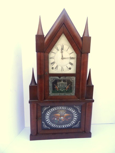 Terry and Andrews Double Candlestick Clock: Terry & Andrews double candlestick clock, 8 day time & strike, brass movement, mahogany veneer case, 25 in. (h)
