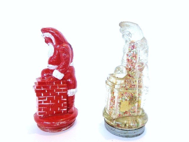 Pair of Early Santa Claus Glass Candy Containers: Pair of early glass Santa going down chimney glass candy containers, 5.25 in. (h), clear example w/closure has crack in head, repainted example has chip on back