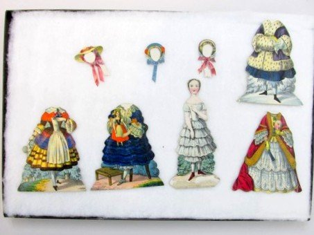 My Little Christmas Doll 1850's Set: Great early set includes 4 1/8" double sided cardboard doll with four double sided costumes and three bonnets, in display case