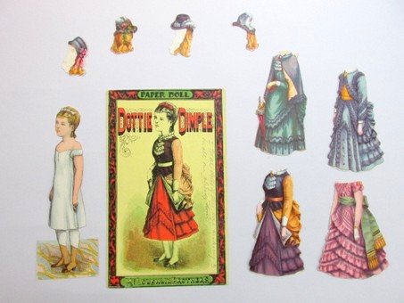 Three McLoughlin Paper Dolls: Three early Mcloughlin Sets, Jennie June uncut 6" doll with uncut sheet containing four costumes and bonnets with original envelope, Dottie Dimple 8" H with four costumes and four bonnets with origina