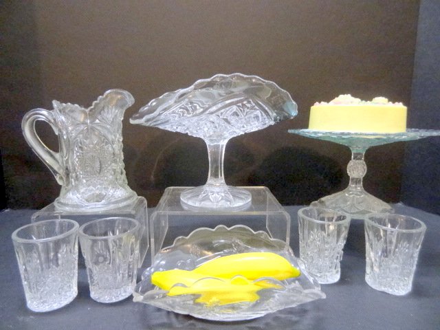 Children's Glassware: Children's glassware consisting of oval star water set by Indiana Glass Co., 2 banana stands, 1 Rexford, 1 unknown, & palm leaf cake plate, 4 3/4in. Tallest