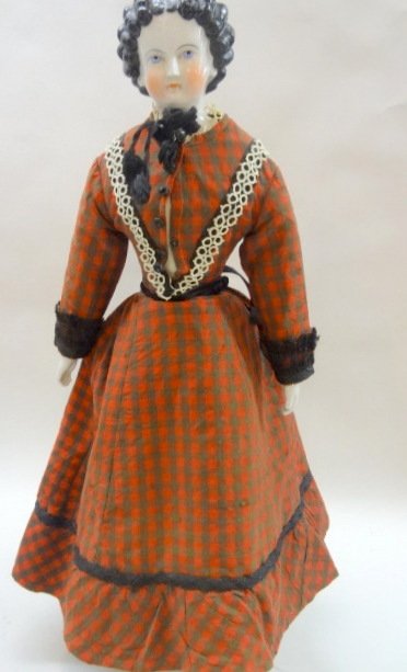 China Lady, 1860's Waterfall Hairstyle Doll: Waterfall hairstyle China lady, 23in. w/blue painted eyes, pink lid lines, black hair, 5 curls down each side of face, curls gathered & pulled up in the back, cloth body, china hands, great vintage cl