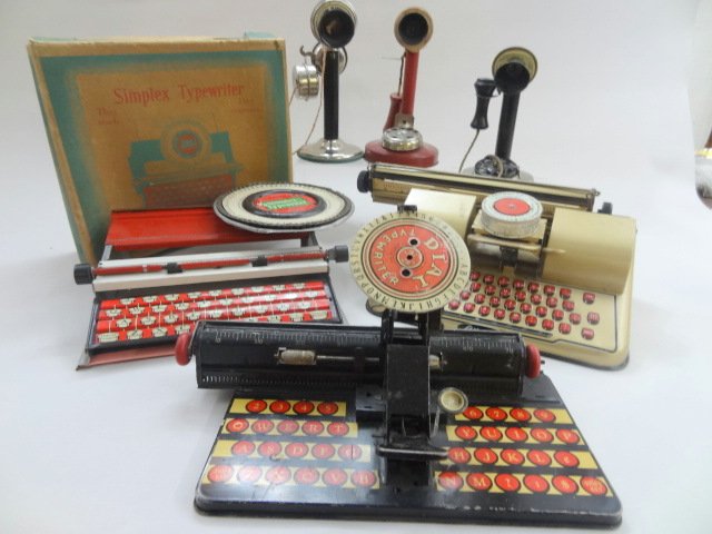 Early Tin Typewriters and Phone Toys: Group of 7 early tin toys, 3 typewriters - include Marx, Berwin & Simplex in box & 4 telephones one w/bank