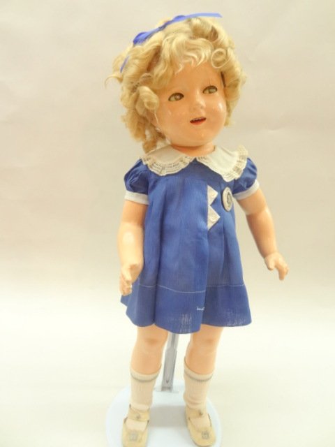 Ideal Twenty-Four inch Shirley Temple Original Doll: Ideal 24in. Shirley Temple, in original tagged dress w/pin, center snap shoes & white socks, all composition, sleep eyes, open mouth, dimple in cheeks, original wig