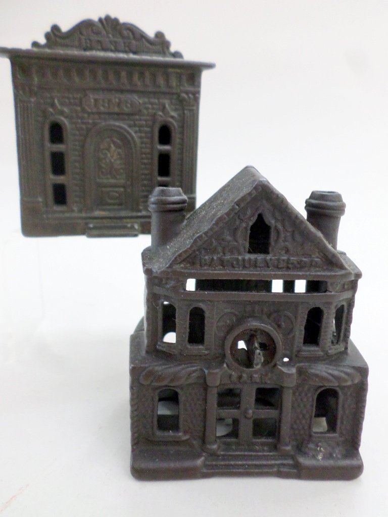 Pair Cast Iron Building Banks: Pair of cast iron antique building banks, 1876 bank w/marquee on top 3 1/4in. (H) & bank w/2 chimneys 3 1/2in. (H)