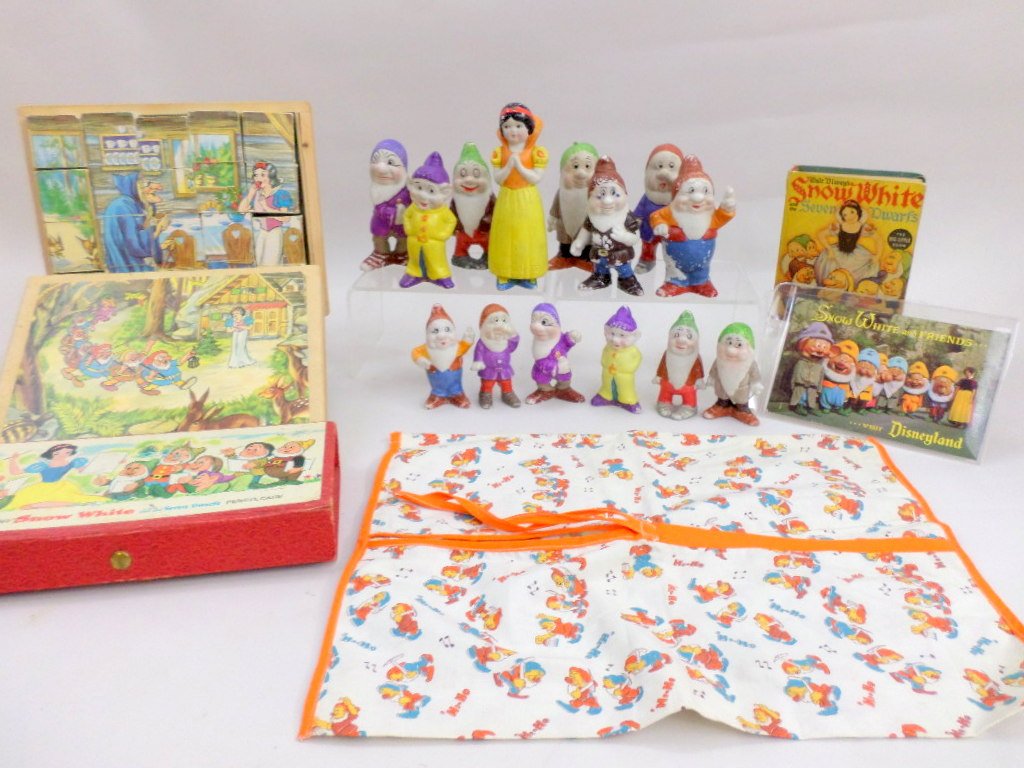 Snow White Figures, Book, Blocks: Gouping of Snow White and Seven dwarfs ceramic figures marked w/copyright Walt Disney, one set of dwarfs missing snow white, 1938 Snow White book, blockset, pencil case with added contents, and clothe