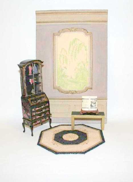 Elegant Vignette Dollhouse Miniatures: An hand-painted wall panel featuring an Asian landscape en grisaille 11" H, 7" W (slight cornice damage) setting off a decorated secretaire 6.5" H (one rear leg repaired) containing four mud figures o