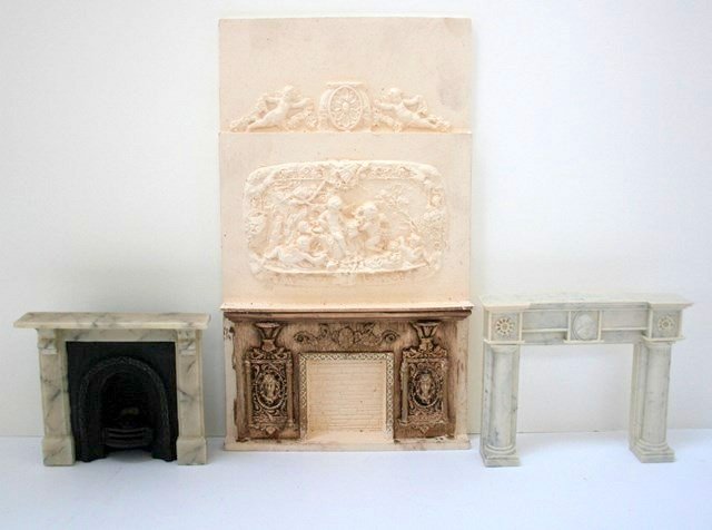 Fancy Fireplaces: An imposing cast resin fireplace with chimney breast 10.5" H, 6.25" W, partially finished and can be trimmed to a shorter height, and two smaller marble-finished resin fireplaces, one with Victorian f