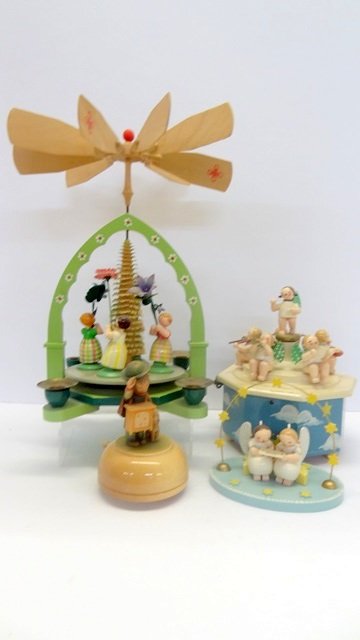 German Wood Music Boxes & Others: Rotating music box with angel band 7" H, organ grinder with dog music box, wind powered rotating scene with four candle sockets 11" H and Erzgebirge angels reading song sheet 4.5" H