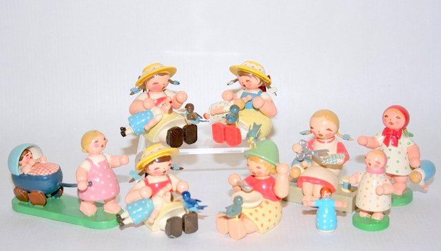 Wendt & Kuhn Girls At Play: An assortment of eight seated and standing hand-painted figures engaged in various activities with their dolls, sewing, or playing with birds. Approx. 2" H.