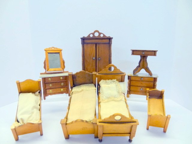 Schneegass Dollhouse Bedroom Furniture: Antique Schneegas dollhouse beds in various sizes, sewing table, armoire, marble top dresser and chest. Tallest 6 1/2in.