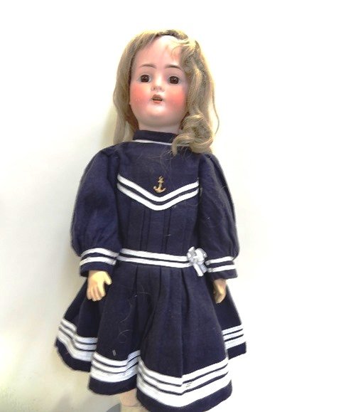 Bruno Schmidt Twenty-four-one-half inch Bisque Doll: Bruno Schmidt 24 1/2 in. bisque head on jointed composition body, brown eyes are set, open mouth, human hair wig, dressed in navy blue wool flannel dress